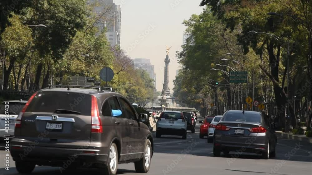 Paseo Reforma, traffic in the street, angel independence square background, accelerated vision Paseo Reforma, traffic in the street, angel independence square background, accelerated vision