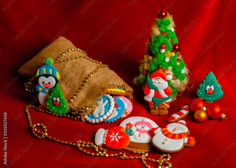 Christmas tree and gingerbread cookies on a red background