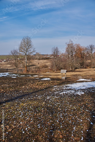 Park landscape with a well.Spring landscape in the park of the estate of the Pushkin family. Visible trees with bare branches without foliage. In the center of the composition is a well. Russia