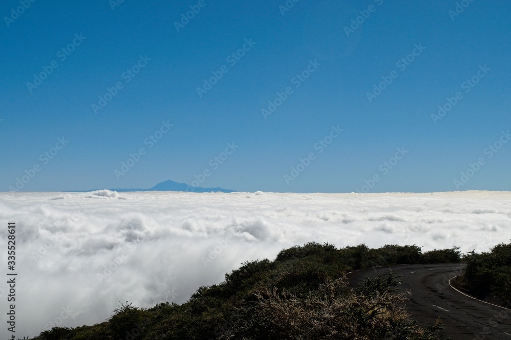 Looking at Teide from La Palma over a sea of clouds by the road