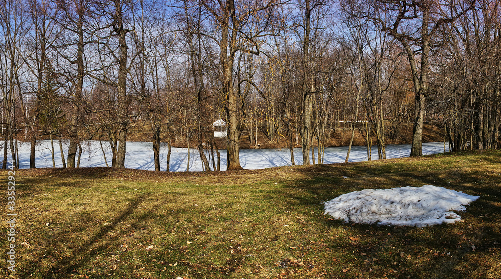Park landscape.Spring landscape in the park of the estate of the Pushkin family. Visible trees with bare branches without foliage, in some places there is snow. Russia, the village of Big Boldino Park landscape.Spring landscape in the park of the estate of the Pushkin family. Visible trees with bare branches without foliage, in some places there is snow. Russia, the village of Big Boldino