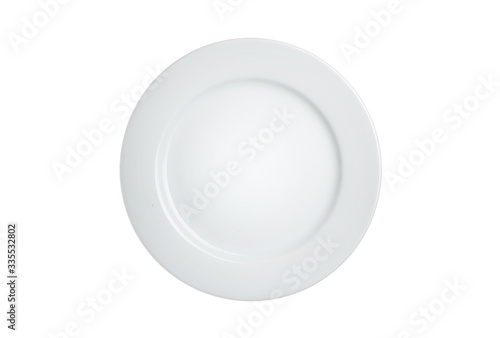 Empty white plate on a wooden table.