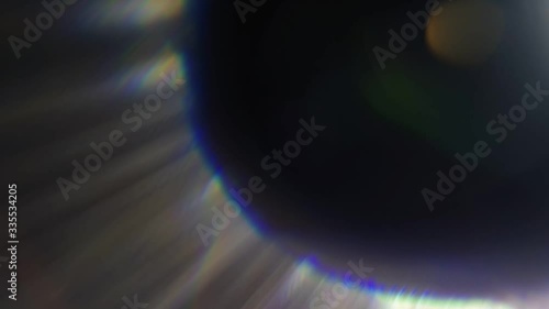 Beautiful abstract defocused lens flare on a dark background. Real light leaks and lens flare.