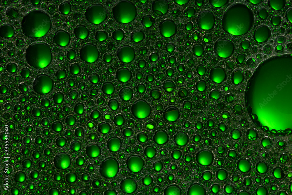 Abstract Green water bubbles background. Oil and  Water  . Texture foam close up .Soft focus