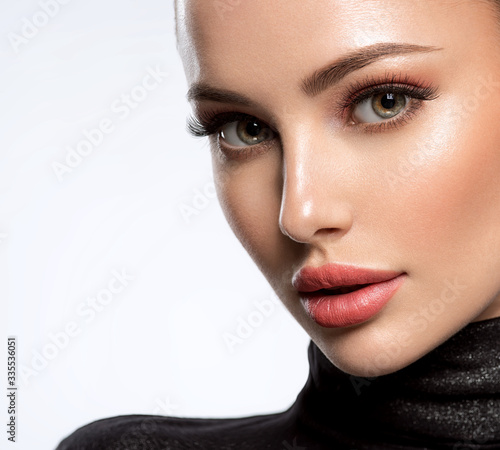 Portrait of beautiful young woman with bright pink makeup. Beautiful brunette with bright orange lipstick on her lips.