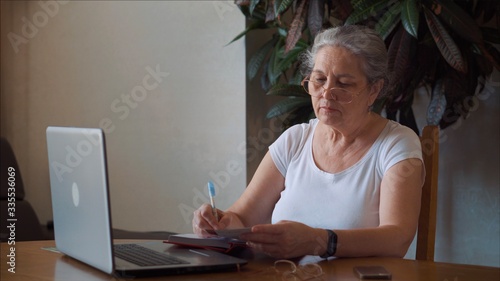 Coronavirus. Quarantine. Senior Woman finish freelance work at home