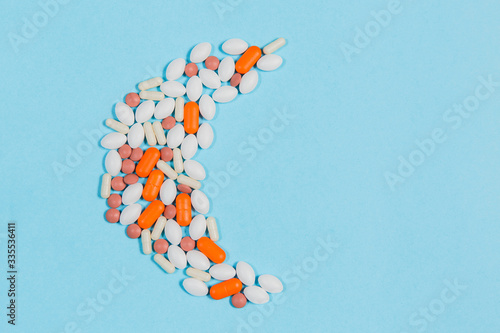 Different pills on a blue background. health and medicine
