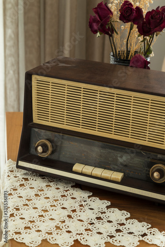 The old vintage radio on the wooden table.