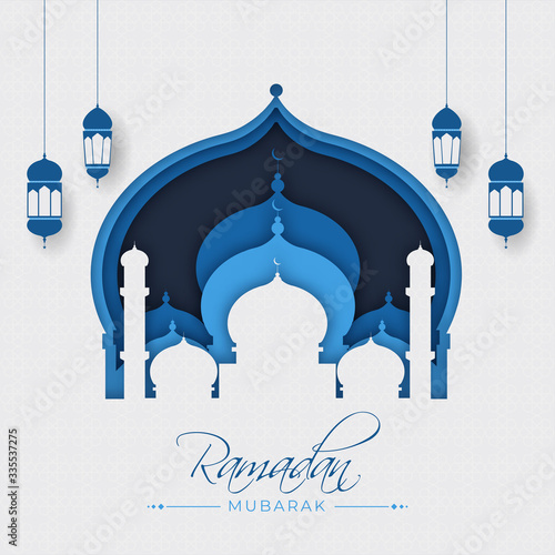 Islamic Holy Month of Ramadan Kareem with paper mosque ad hanging lanterns.