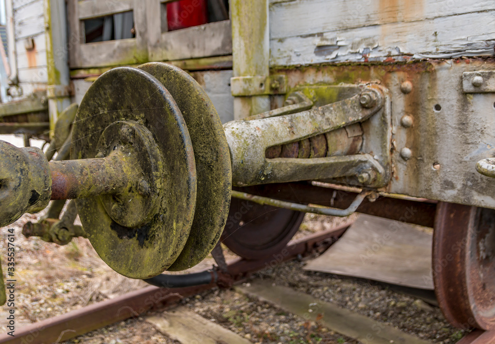 Old train carriage on rails, white wooden train carriage. Old style hook railway coupling Old train carriage on rails, white wooden train carriage. Old style hook railway coupling