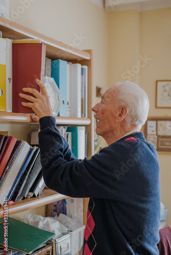 Elderly man reading book at home