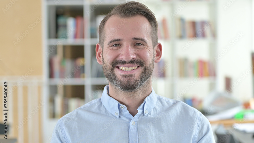 Obraz premium Portrait of Cheerful Young Man Smiling At Camera