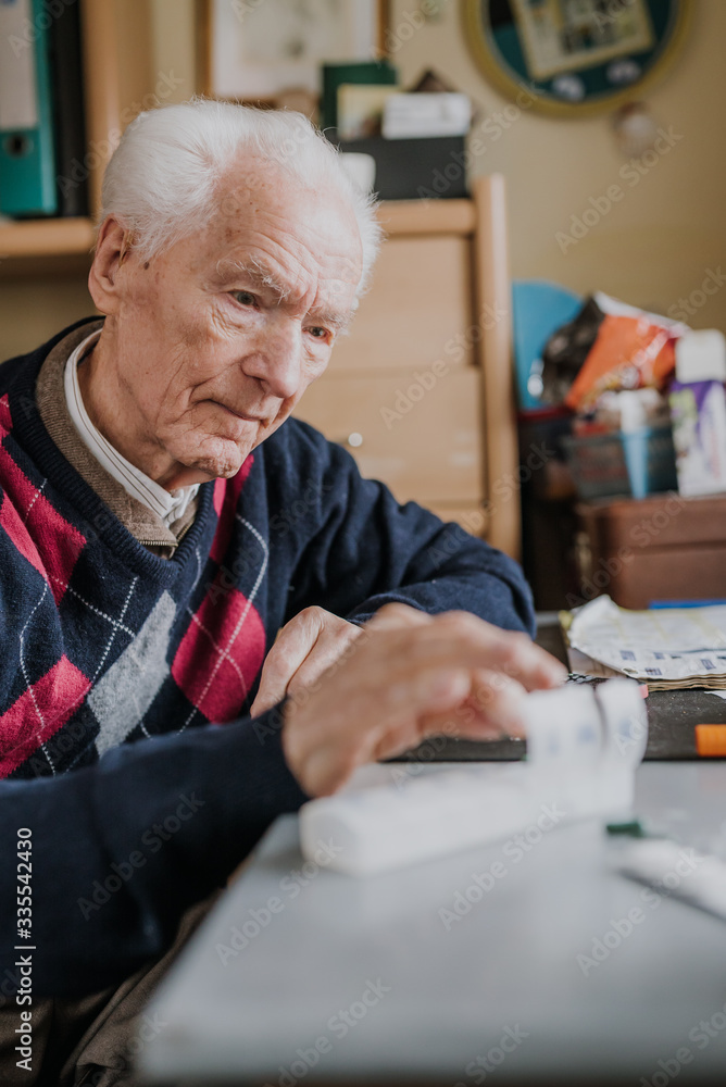 Senior arranges medicines for each day of week Senior arranges medicines for each day of week