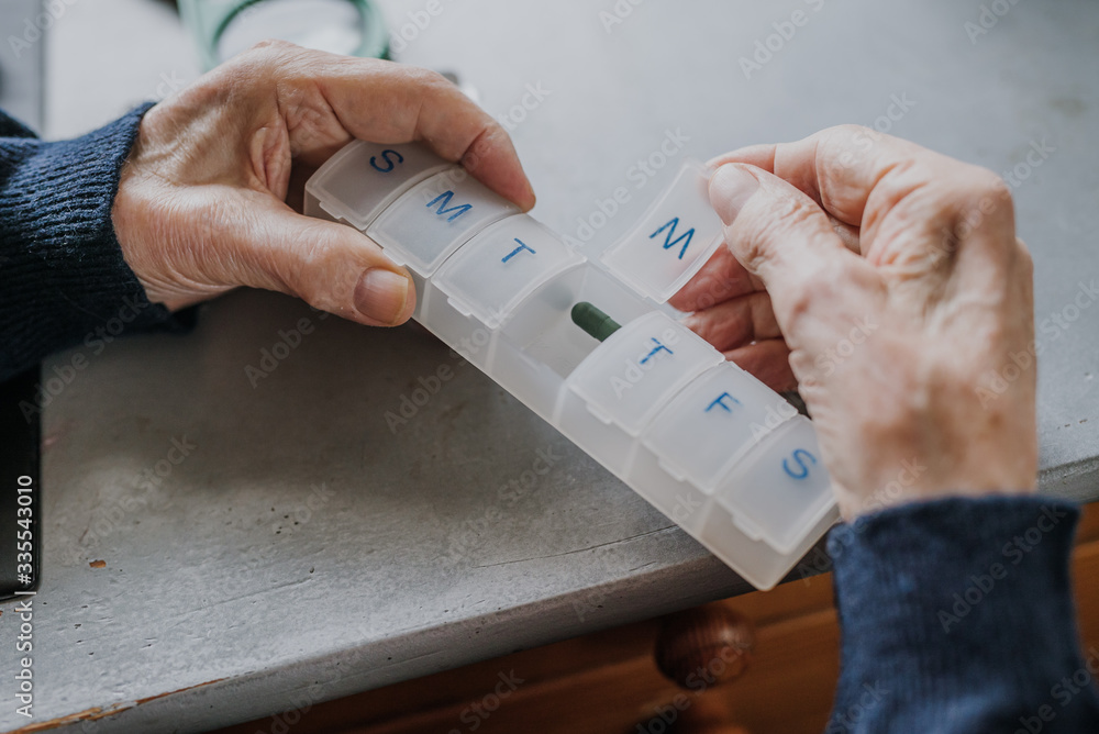 Senior arranges medicines for each day of week Senior arranges medicines for each day of week