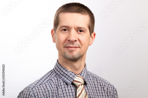 A man in a cage shirt and tie. Close up