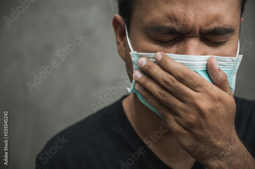 Close up young asian man wearing protection face mask against coronavirus.