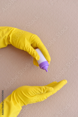Sanitizer in hands in latex glove