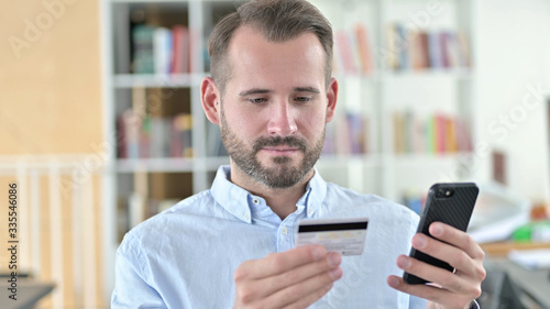 Portrait of Online Payment Success on Smartphone by Man