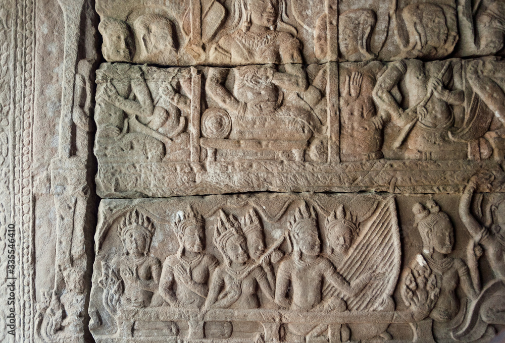 Carved gallery with royal entertainment, musicians with instruments on the 12th century bas-relief of Bayon temple, Cambodia. Historical landmark in Angkor. UNESCO world heritage site