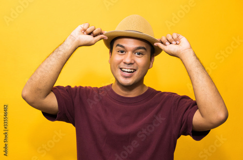 Smiling Happiness young asian man on yellow background