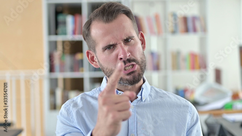 Portrait of Aggressive Young Man Angry on Video Chat