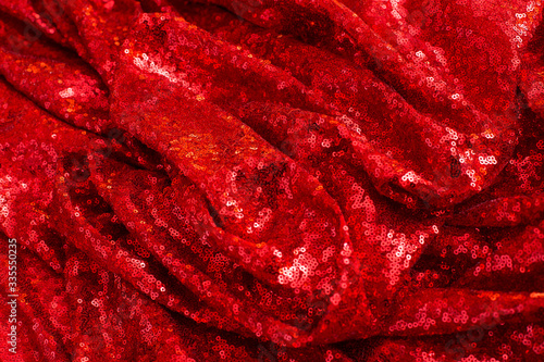 red shiny sequined pleated sequin fabric as background and texture
