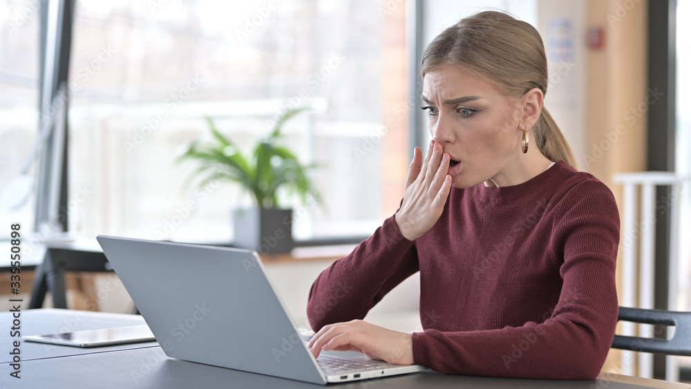Young Woman in Shock by Results on Laptop in Office Young Woman in Shock by Results on Laptop in Office