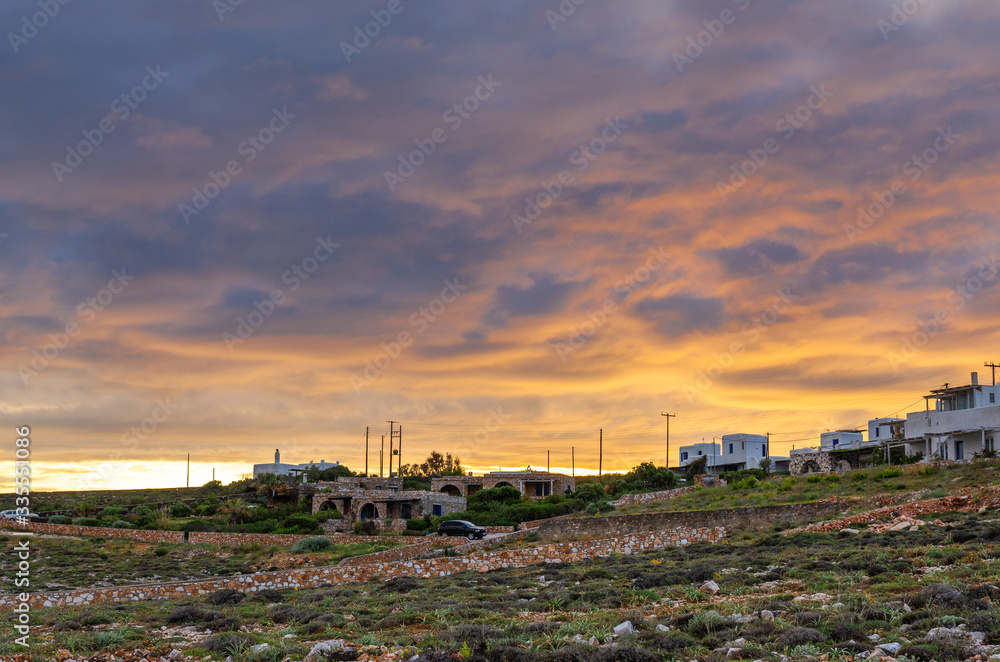 Beautiful sunset with amazing clouds over Paros island in Greece