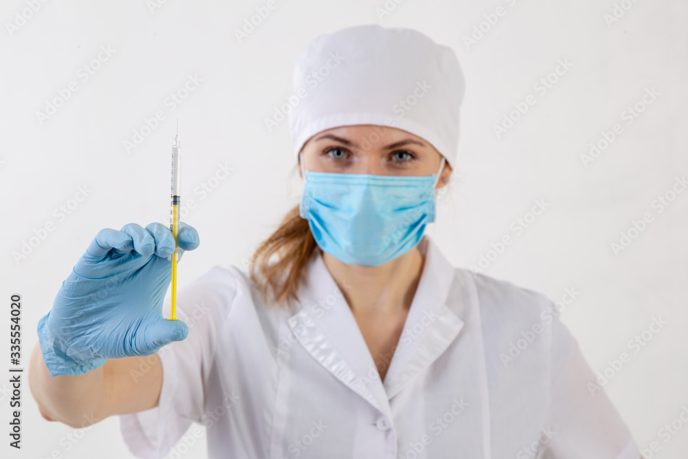 Doctor in a white coat holding a syringe. Doctor in a white coat holding a syringe.