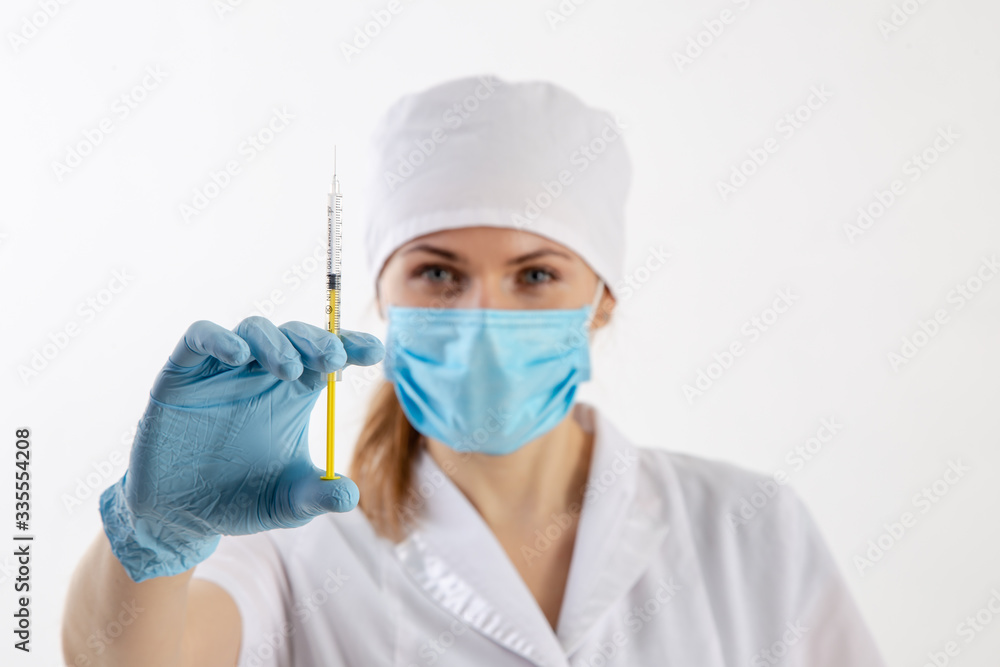 Doctor in a white coat holding a syringe. Doctor in a white coat holding a syringe.