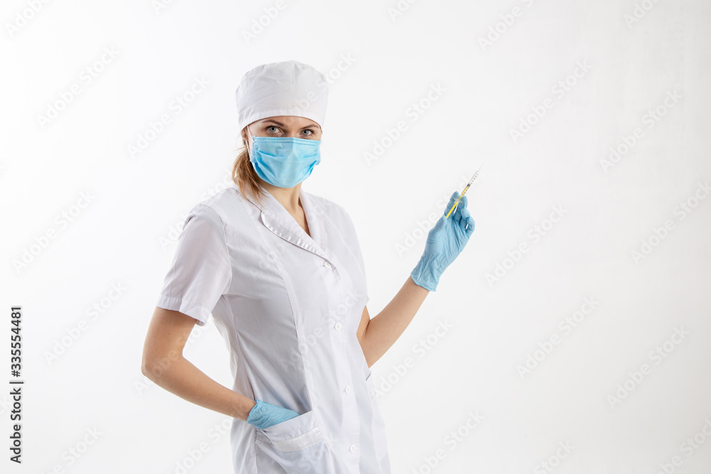 Doctor in a white coat holding a syringe. Doctor in a white coat holding a syringe.