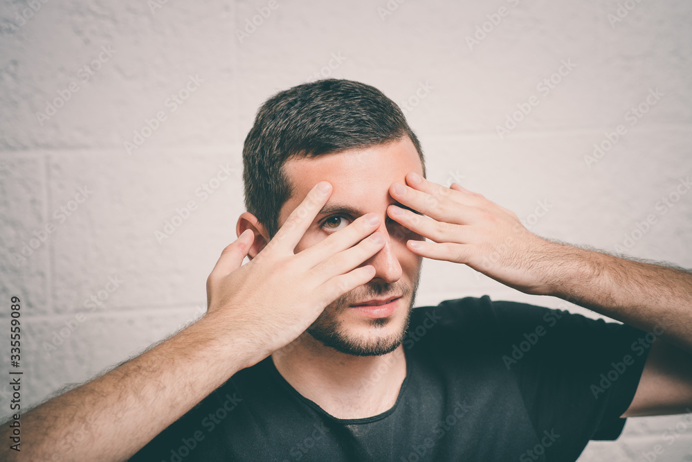 Man closes eyes with her hands Man closes eyes with her hands