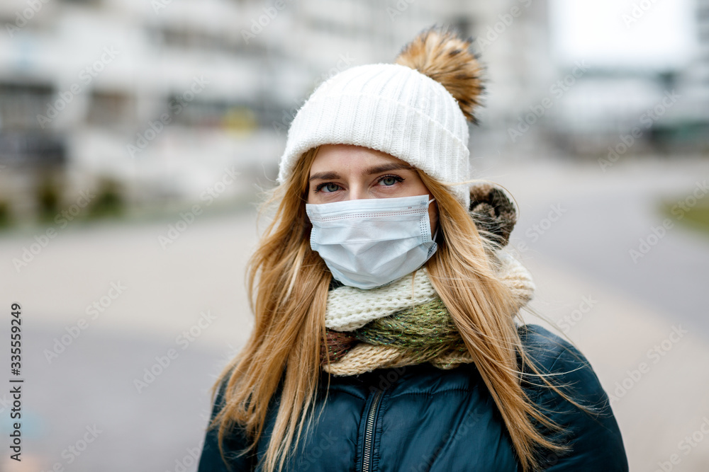 The woman wears a protective mask from allergies, viruses, air pollution. Concept climate change. The woman wears a protective mask from allergies, viruses, air pollution. Concept climate change.