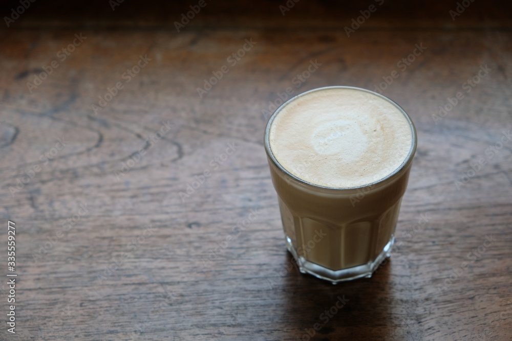close up one glass of coffee on old wooden table. blur background close up one glass of coffee on old wooden table. blur background