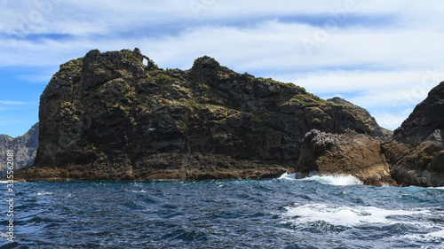 Rugged, rocky Tiheru Island ("The Dog") in the Bay of Islands, New Zealand. Many seabirds nest on its crags