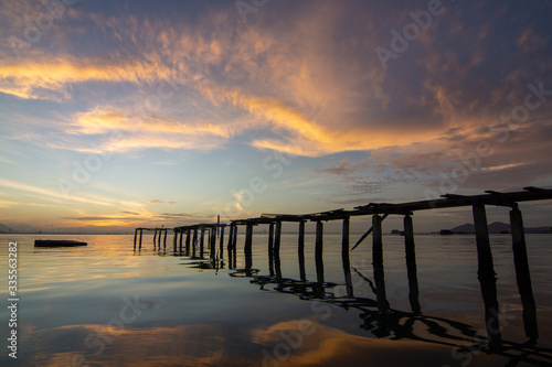 Wooden bridge on sea at Jelutong, Penang in beautiful dawn hour. © Cloudyew