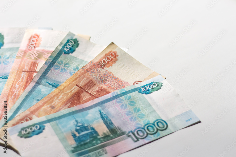 Russian banknotes on a white background in bright light with a copy of the space Russian banknotes on a white background in bright light with a copy of the space