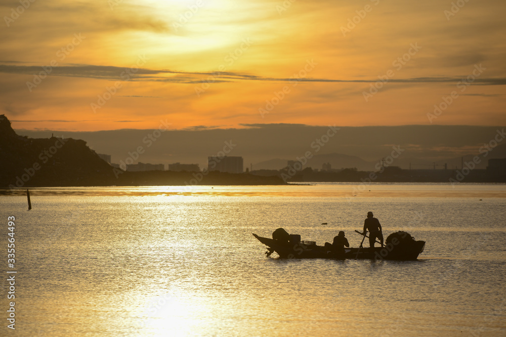Silhouette fisherman fishing in sea in morning.
