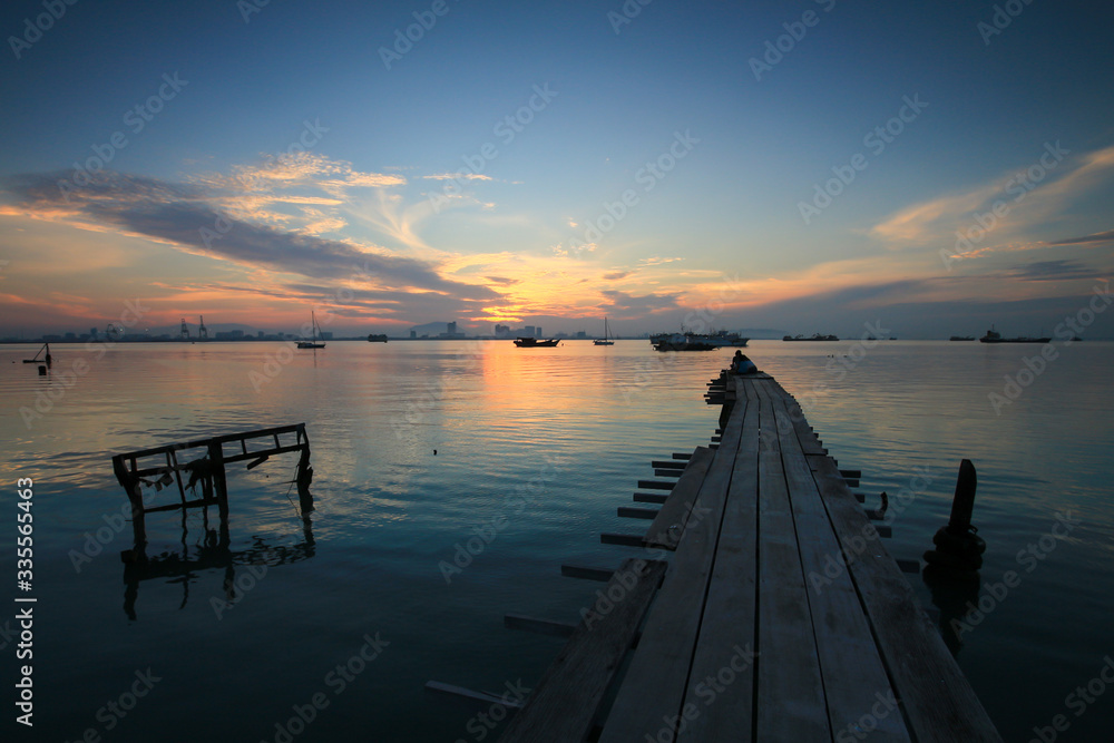 Wooden bridge at Tan Jetty, Georgetown, Penang, Southeast Asia during sunrise hour.