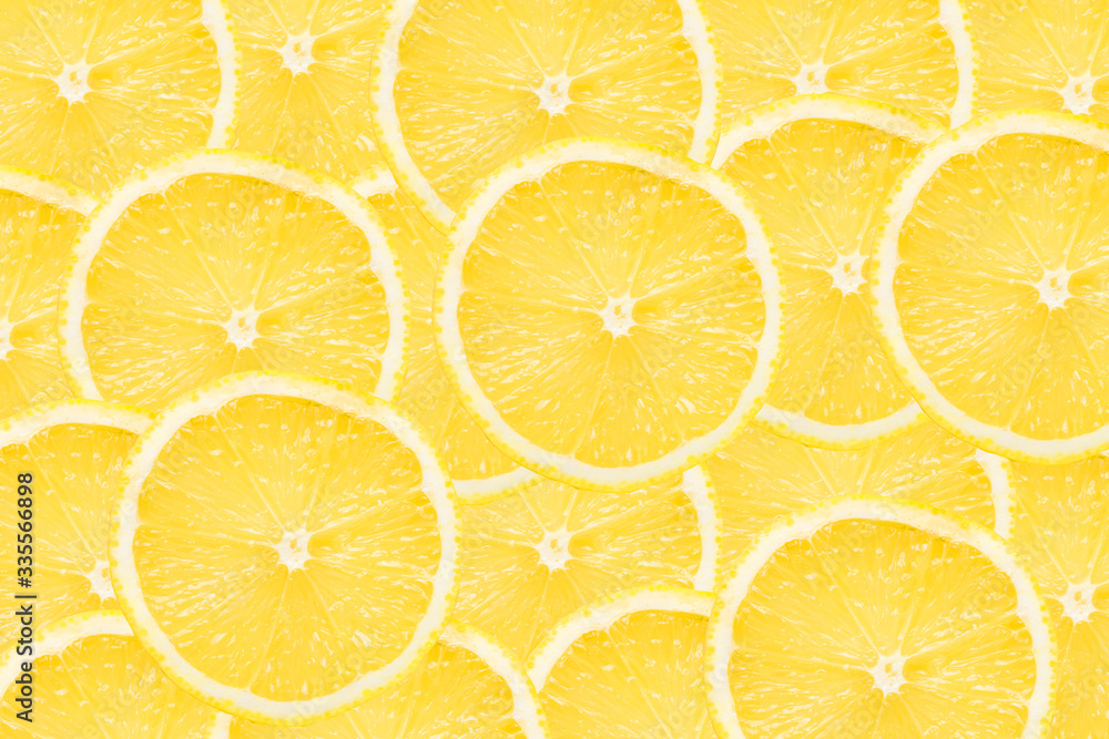 Lemon slices background. Yellow fruit cut texture. Citrus section pattern. Vibrant color summer design.	