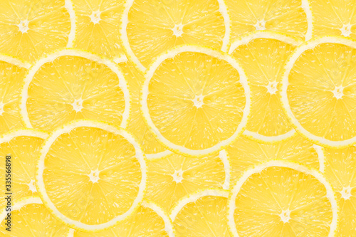 Lemon slices background. Yellow fruit cut texture. Citrus section pattern. Vibrant color summer design. 