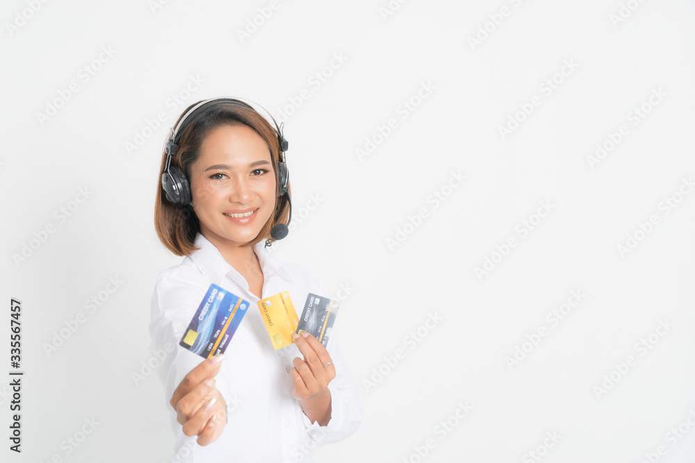 Woman call center with headset holding and credit card. Woman call center with headset holding and credit card.