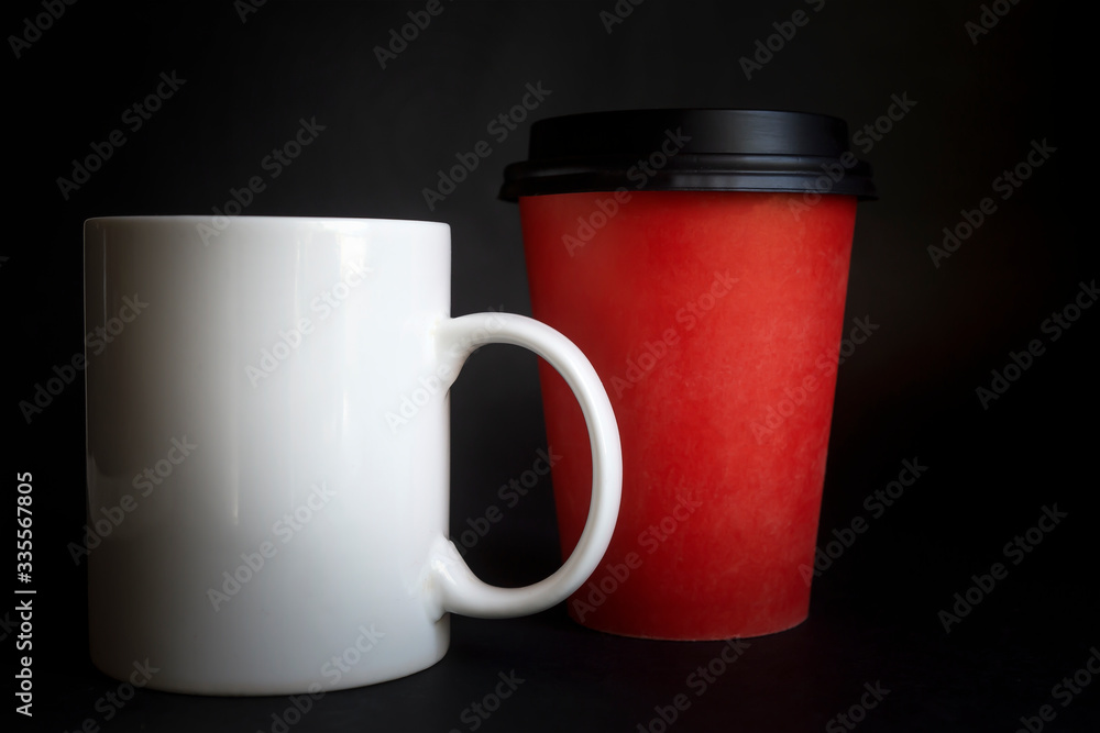 Obraz premium Large, medium, small cups for coffee against a dark background.
