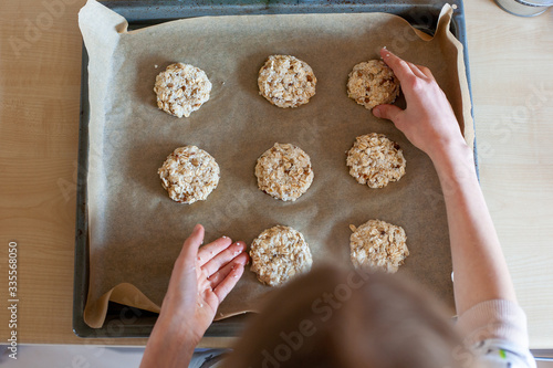 Tray of easy to prepare and healthy, home made outmeal cookies – made by a little girl photo