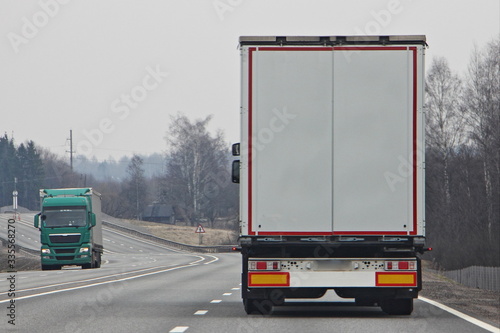 Trucks with on highway road at spring day, commercial transportation