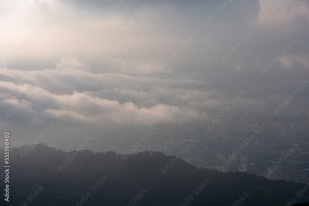 Sea Cloud cover Georgetown in hazy morning. View from Penang Hill.