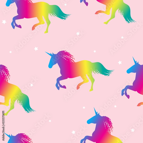 Rainbow unicorns on a pink background with a stars. Seamless pattern.