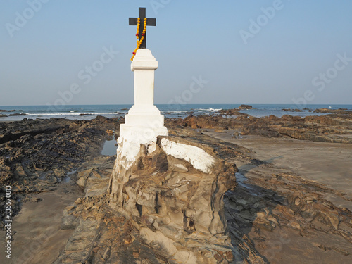 Santa Khuris Mannar Chapel at Morjim beach. Catholic cross located on the beach by the sea photo