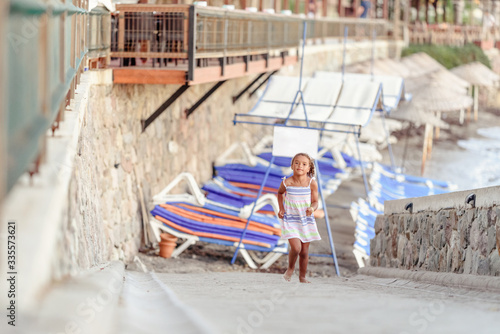 happy  little girl have fun and joy time at beautiful beach