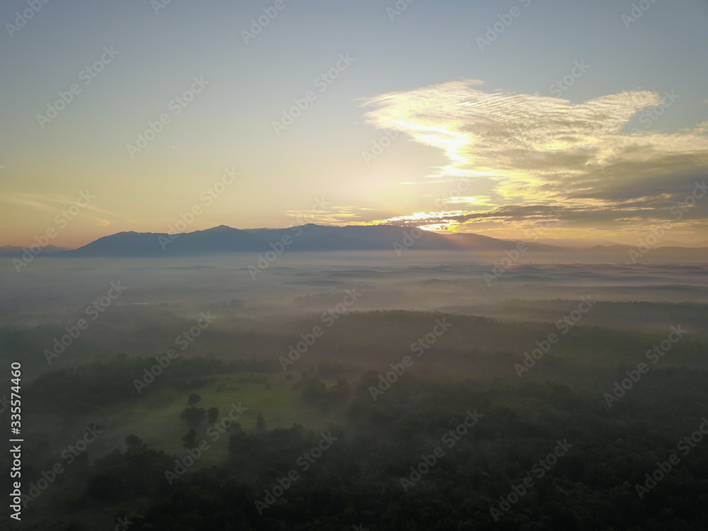Aerial view foggy green forest at Kedah, Malaysia. Background is Mount Bintang.